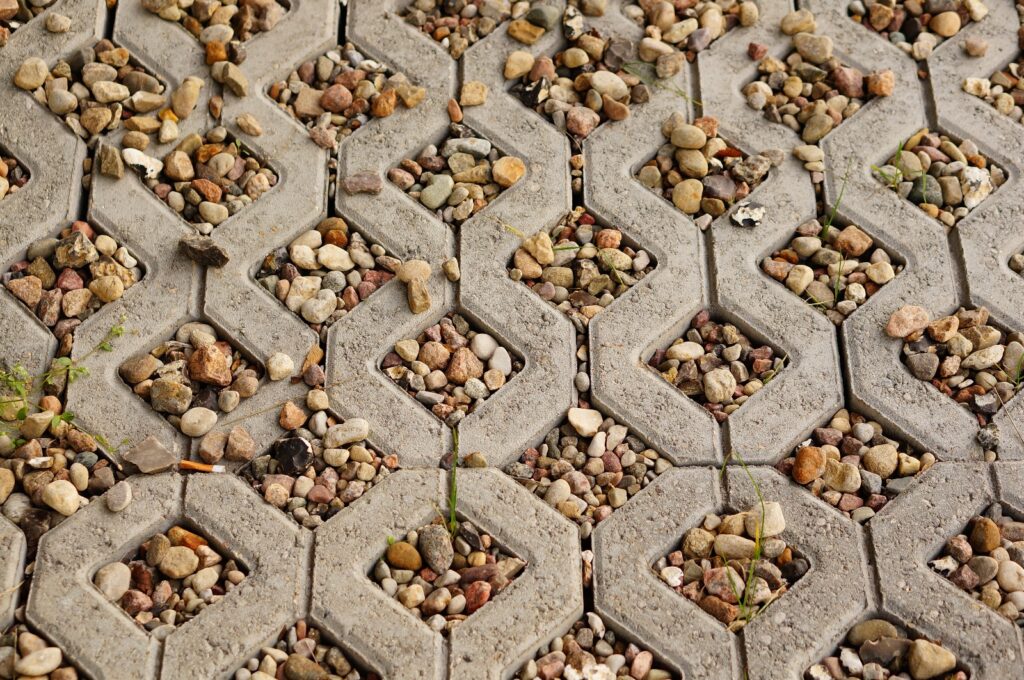 A photo showing a close up of a tiled floor with rocks and stones